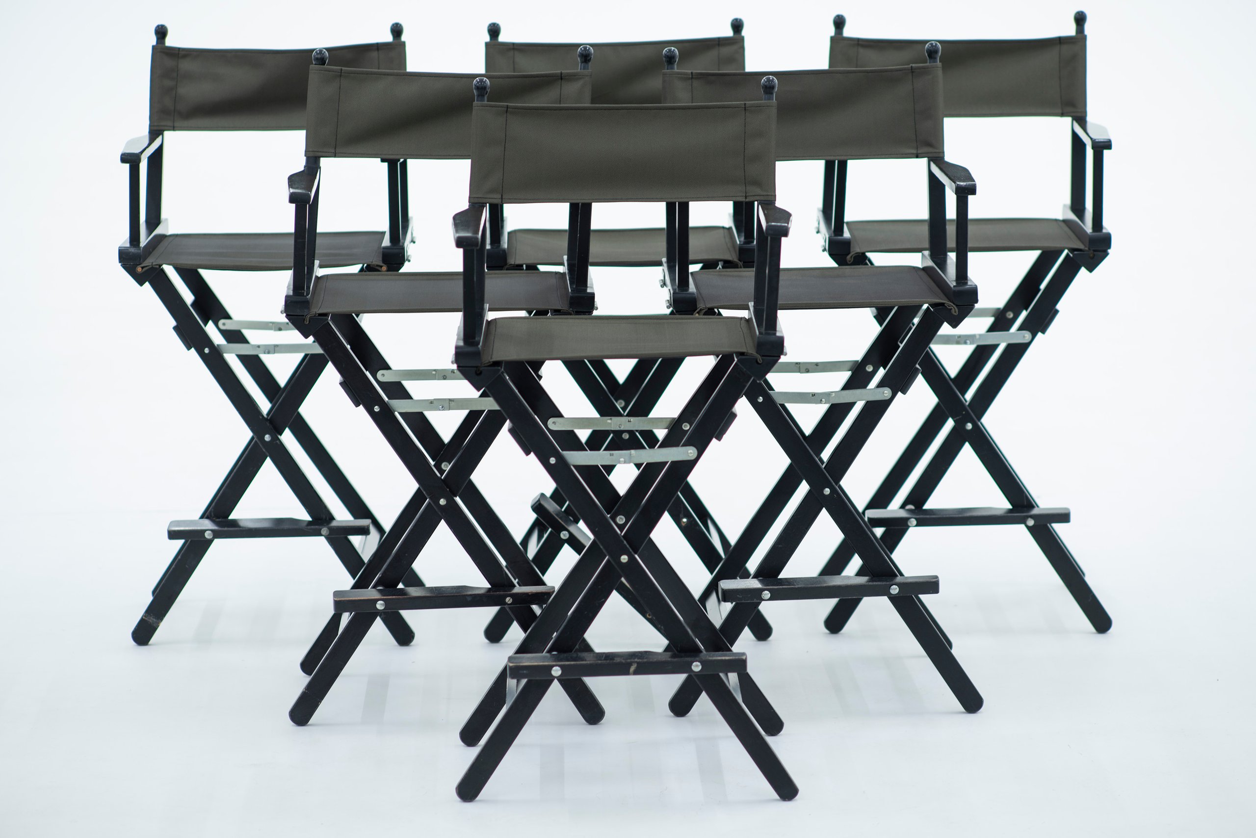Picturepool Studios equipment — multiple black director's chairs against a white background