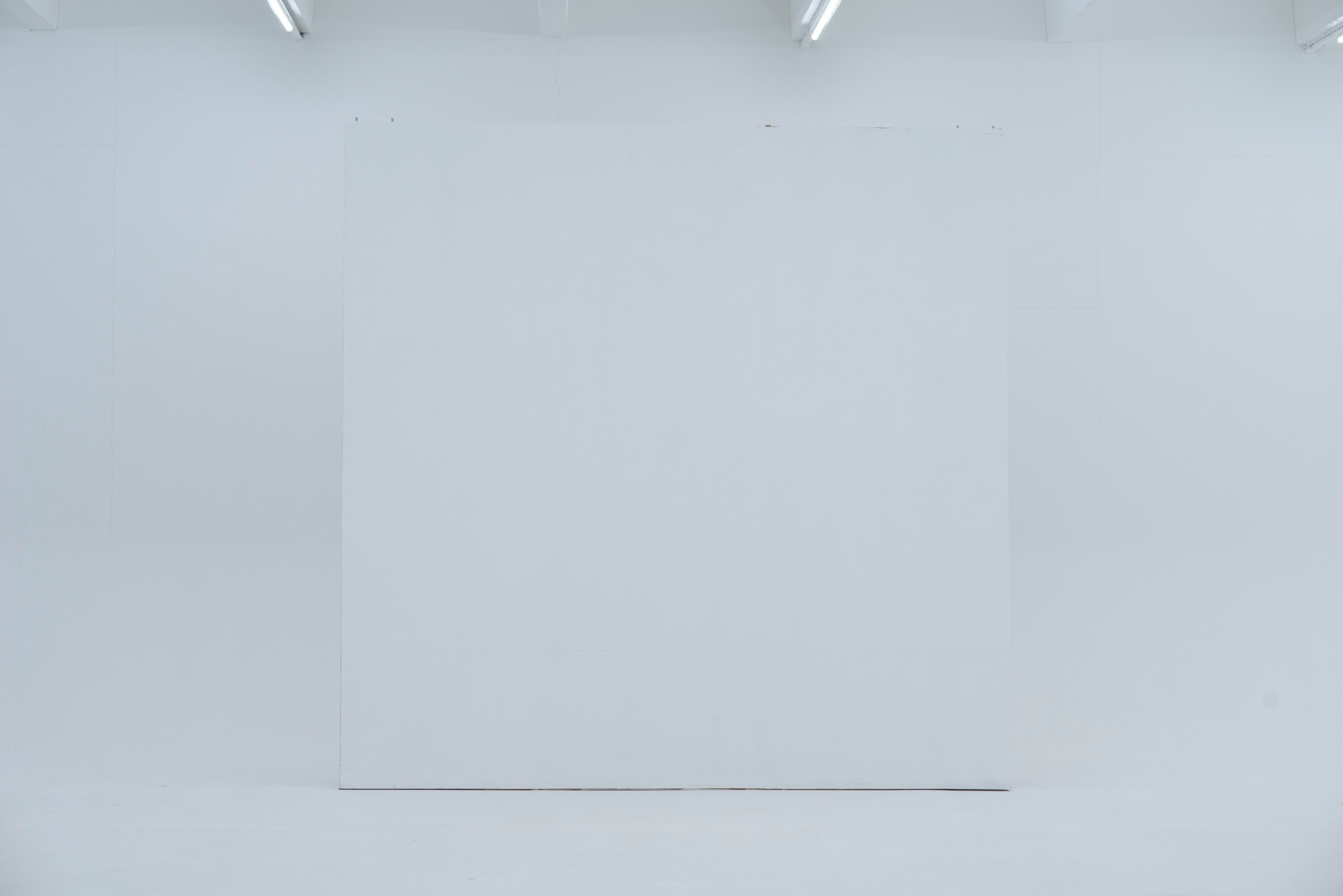 Picturepool Studios equipment — large white mobile wall panel in a room with fluorescent ceiling lights