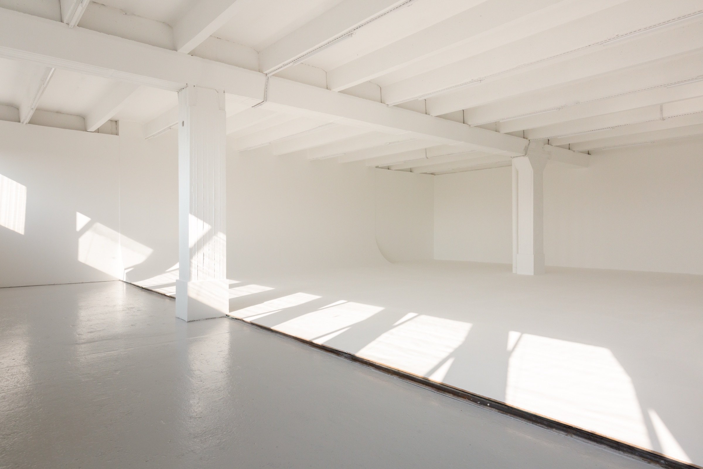 Picturepool Studios studio interior — bright white space with exposed ceiling beams, natural light and infinity cove